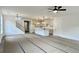 Spacious living room connected to kitchen, featuring stairs, neutral walls, and modern fixtures at 8629 Connor Ct, North Charleston, SC 29406
