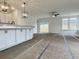 Open-concept living space with white walls, kitchen island, modern lighting, and sliding doors at 8629 Connor Ct, North Charleston, SC 29406