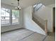 Bright living room featuring a modern chandelier, and stairway with wood handrail and black metal spindles at 8629 Connor Ct, North Charleston, SC 29406