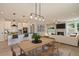 Open-concept kitchen, dining, and living area boasts hardwood floors, modern lighting, and stainless steel appliances at 8629 Connor Ct, North Charleston, SC 29406