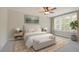 Bright main bedroom features a king-sized bed, neutral decor, and large windows with white shutters for natural light at 8629 Connor Ct, North Charleston, SC 29406