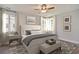 Serene main bedroom features a king-sized bed, neutral decor, and large windows with white curtains for natural light at 8629 Connor Ct, North Charleston, SC 29406