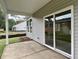 View of the covered back patio featuring vinyl siding and sliding glass door leading to the backyard at 8629 Connor Ct, North Charleston, SC 29406