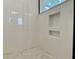 Bathroom shower with a built in wall niche, white subway tile, and mosaic shower floor at 8629 Connor Ct, North Charleston, SC 29406