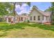 Expansive lawn and landscaping highlight this home's backyard and multiple exterior buildings at 974 Cliffwood Dr, Mount Pleasant, SC 29464