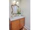 Stylish bathroom featuring a wooden vanity with marble countertop, a gold-framed mirror, and modern lighting at 974 Cliffwood Dr, Mount Pleasant, SC 29464