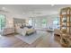 Spacious bedroom with hardwood floors, a large bed, an area rug, and natural light from multiple windows at 974 Cliffwood Dr, Mount Pleasant, SC 29464