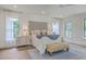 Bright bedroom with hardwood floors, a large bed, matching nightstands, and natural light from multiple windows at 974 Cliffwood Dr, Mount Pleasant, SC 29464