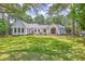 Charming home featuring a well-manicured lawn and beautiful landscape surrounded by mature trees offering a serene setting at 974 Cliffwood Dr, Mount Pleasant, SC 29464