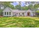 Charming home featuring a well-manicured lawn and beautiful landscape surrounded by mature trees offering a serene setting at 974 Cliffwood Dr, Mount Pleasant, SC 29464