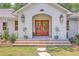 Welcoming entrance with a beautiful front door, brick steps, and elegant lanterns enhancing the home's curb appeal at 974 Cliffwood Dr, Mount Pleasant, SC 29464