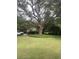 Lush front yard with a mature oak tree offering shade, enhancing the property's curb appeal at 974 Cliffwood Dr, Mount Pleasant, SC 29464