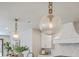 Close-up of a kitchen island with modern pendant lighting and kitchen features at 974 Cliffwood Dr, Mount Pleasant, SC 29464