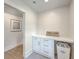 Functional laundry room with custom cabinets and counter space at 974 Cliffwood Dr, Mount Pleasant, SC 29464