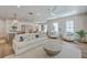Bright living room with hardwood floors, white sofa, and open floor plan leading into the kitchen and dining area at 974 Cliffwood Dr, Mount Pleasant, SC 29464