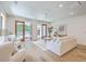 Bright living room with a ceiling fan, neutral decor, and sliding glass doors to the backyard at 974 Cliffwood Dr, Mount Pleasant, SC 29464