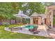 A quaint pool with beautiful lounge chairs is adjacent to the charming white buildings at 974 Cliffwood Dr, Mount Pleasant, SC 29464