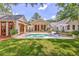 Beautiful pool area with lawn, lounge chairs, and multiple entryways into a charming home at 974 Cliffwood Dr, Mount Pleasant, SC 29464