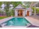 Inviting pool and adjacent cottage with beautiful outdoor lounge space and manicured lawn at 974 Cliffwood Dr, Mount Pleasant, SC 29464