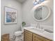 Stylish powder room featuring vanity with marble counters, patterned tile floor, and decor at 974 Cliffwood Dr, Mount Pleasant, SC 29464