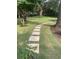 Landscaped yard featuring a stepping stone walkway leading through a beautifully maintained lawn at 974 Cliffwood Dr, Mount Pleasant, SC 29464