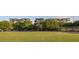 Multi-story building surrounded by trees with a playground and parking lot in the foreground at 1 Cool Blow St # 153, Charleston, SC 29403