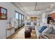 Bright living room boasts large windows, exposed ceilings, hardwood floors, and comfortable seating at 1 Cool Blow St # 153, Charleston, SC 29403