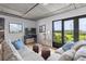 Airy living room featuring neutral colors, exposed ceilings, and abundant natural light from expansive windows at 1 Cool Blow St # 153, Charleston, SC 29403