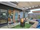 Relaxing rooftop patio with a cozy seating area, fire pit, wood pergola, and sliding glass doors at 1 Cool Blow St # 153, Charleston, SC 29403