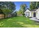 A spacious backyard featuring a lush lawn, mature trees and shrubbery, and a well-maintained wooden perimeter fence at 103 Case Ct, Ladson, SC 29456