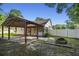 Backyard features a covered patio, fire pit, privacy fence, and mature trees at 103 Case Ct, Ladson, SC 29456