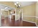 Open dining area with chandelier, seamlessly connecting to the kitchen and living room at 103 Case Ct, Ladson, SC 29456