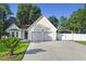 Charming single-Gathering home featuring an attached two-car garage and a long drive leading to a covered parking area at 103 Case Ct, Ladson, SC 29456