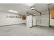 Spacious garage featuring a concrete floor, shelves, and ample storage space, with an open refrigerator in the center at 103 Case Ct, Ladson, SC 29456