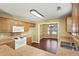 Well-lit kitchen featuring stainless steel sink, wooden cabinets, and white appliances at 103 Case Ct, Ladson, SC 29456
