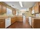 Bright kitchen offering wooden cabinets, white appliances, and plenty of counter space at 103 Case Ct, Ladson, SC 29456