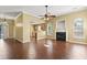 Open living space with hardwood floors, a fireplace, crown molding, and views of the kitchen and the front entryway at 103 Case Ct, Ladson, SC 29456