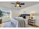 Comfortable bedroom features a ceiling fan, a window, and a bed with decorative pillows on top of an area rug at 105 Conductor Ct, Summerville, SC 29486