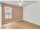 This empty bedroom offers hardwood floors, a large window, and plenty of natural light at 105 Conductor Ct, Summerville, SC 29486