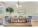 Dining area with rustic wooden table, bench, and chandelier lighting at 105 Conductor Ct, Summerville, SC 29486