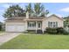 Charming single-Gathering home with manicured lawn, two-car garage, and inviting front porch with green shutters at 105 Conductor Ct, Summerville, SC 29486