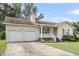 Front exterior with a well-manicured lawn, an attached garage, and a cozy front porch at 105 Conductor Ct, Summerville, SC 29486
