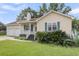 Charming single-story home with well-manicured lawn, lush landscaping, and a welcoming front porch at 105 Conductor Ct, Summerville, SC 29486