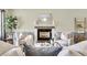 Inviting living room featuring a fireplace, plush armchairs, and stylish decor at 105 Conductor Ct, Summerville, SC 29486