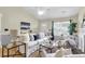 Bright living room features vaulted ceilings, large windows, and stylish neutral decor at 105 Conductor Ct, Summerville, SC 29486