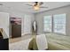 Serene bedroom with a wooden dresser, wall-mounted TV, a large mirror, and bright windows at 1069 Lexi Ct, Ladson, SC 29456