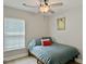 A bedroom with a ceiling fan and a window provides ample natural light at 1069 Lexi Ct, Ladson, SC 29456