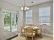 Dining room features a round wooden table, wicker chairs, and sliding glass doors to a patio at 1069 Lexi Ct, Ladson, SC 29456