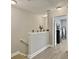 Upstairs hallway featuring wood-look flooring, neutral paint, and stylish staircase at 1069 Lexi Ct, Ladson, SC 29456