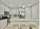 Bright kitchen features granite counters, stainless steel appliances, and ample white cabinetry at 1069 Lexi Ct, Ladson, SC 29456